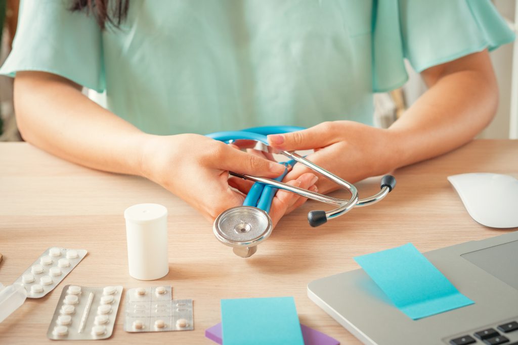 female medical doctor sitting at her office health